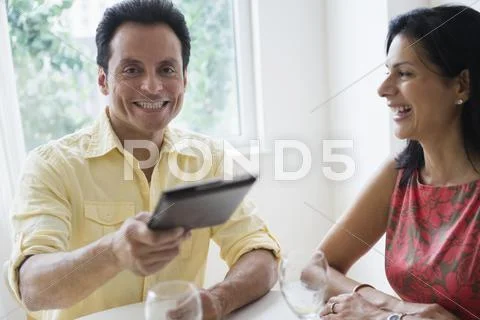 Couple Paying Check In Restaurant