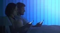 The couple phone on the bed. night time 4k or 4k+ Resolution