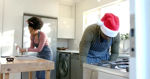 Couple picking up spray can and starting baking tray coating in kitchen, 스톡 동영상 341736196