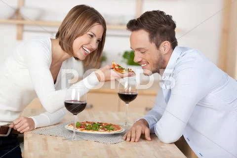 Couple with pizza Stock Photos