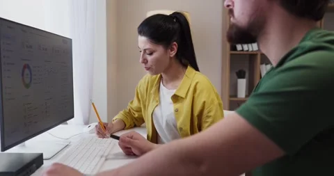 Couple planning budget on computer, tracking expenses and savings at home Stock Footage 338297091