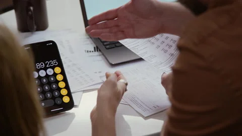 Couple Planning Finances Hands Gesturing Holding Calculator and Documents Stock Footage 327682168