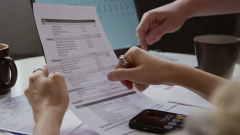 Couple Planning Finances Hands Pointing at Bills and Documents Stock Footage 327683131