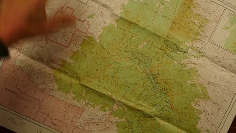 A couple planning a hike with a topo map Stock Footage 83863285