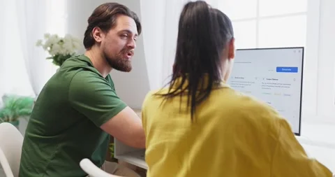 Couple planning household budget using online finance dashboard on home computer Stock Footage 336187463