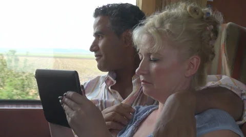 Couple play digital tablet computer train electronic touchscreen woman man Stock Footage 28696591