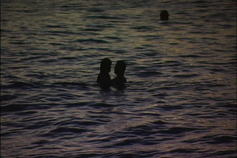 Couple Play in the Surf at Dusk Stock Footage 419957