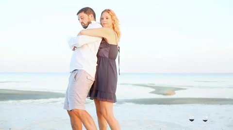 A couple playfully dancing on the beach Stock Footage 56472425