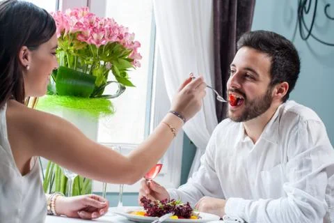 Couple playing around at dinner table. Stock Photos