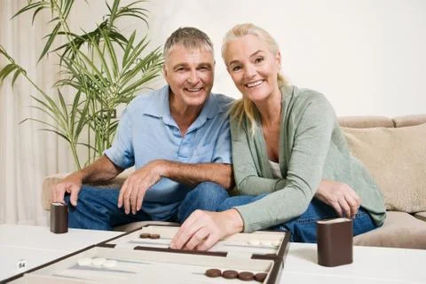 Couple playing backgammon Stock Photos