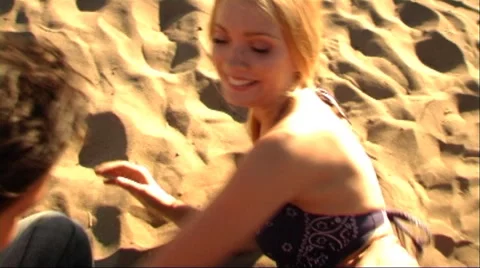 Couple playing on beach Stock Footage 43688569