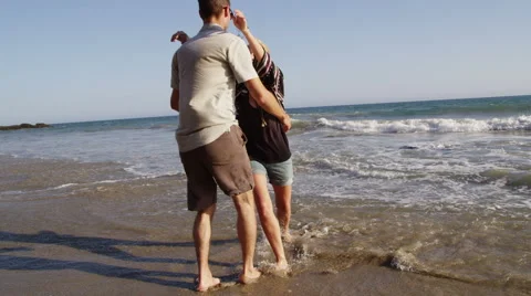 Couple playing on the beach Stock Footage 62345296