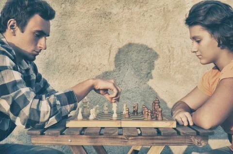 Couple playing chess Stock Photos