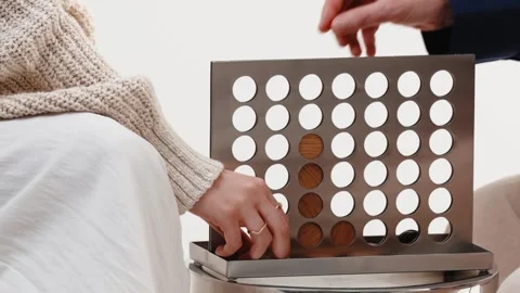 Couple Playing Connect Four Board Game with Wooden Discs at Home Stock Footage 343975862