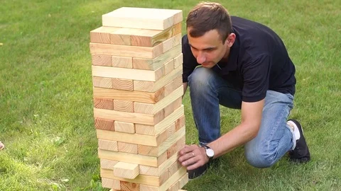 Couple playing a game of jenga in Park on a date. Stock Footage 78214329