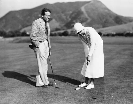 Couple playing golf together Fotos Stock