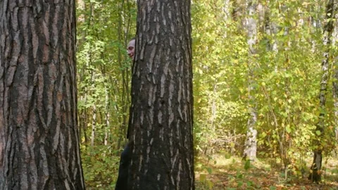 Couple playing hide and seek in autumn forest Stock Footage 314031964