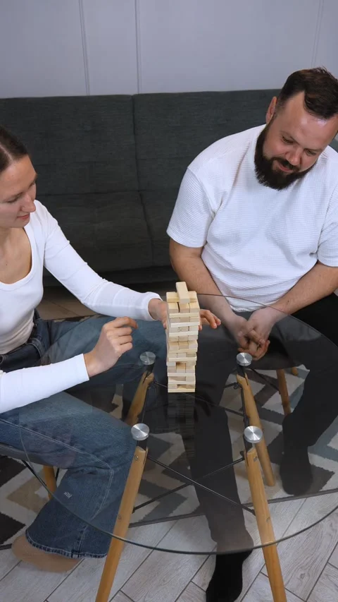 Couple playing jenga, having fun at home Stock Footage 320499887