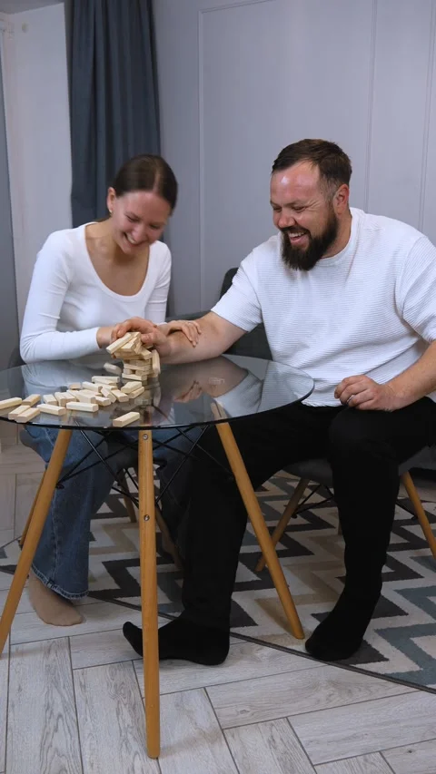 Couple playing jenga, having fun at home Stock Footage 320499967