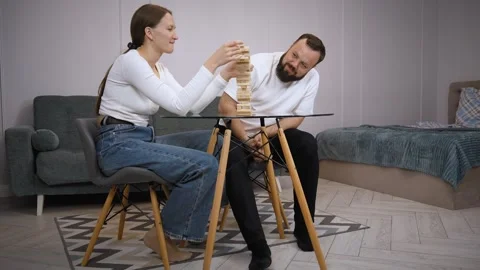 Couple playing jenga, having fun at home Stock Footage 320500048