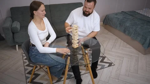 Couple playing jenga, having fun at home Stock Footage 320500067