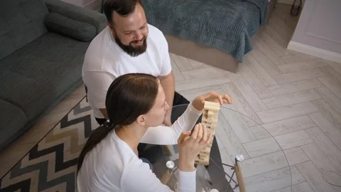 Couple playing jenga, having fun at home Stock Footage 320500108