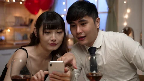 Couple playing with mobile phone Video stock 168751789