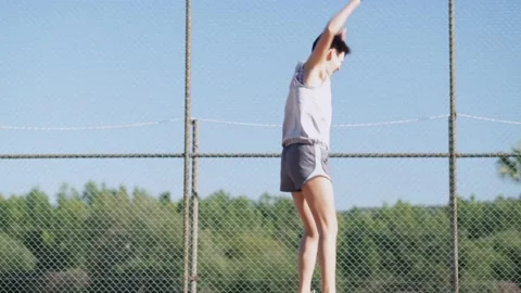 Couple playing pickleball game, hitting pickleball yellow ball with paddle Stock-Footage 229472990