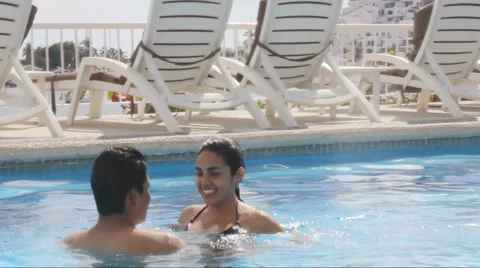 Couple playing in pool Stock Footage 1092313