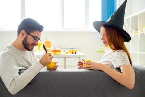 Couple playing with pumpkins Stock Photos