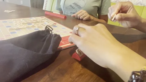 Couple playing scrabble - close up of hands 動画素材 247207722