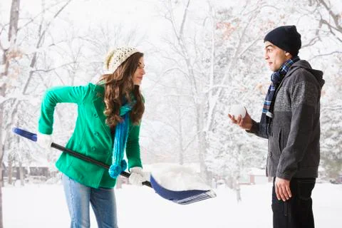 Couple playing in snow Stock Photos