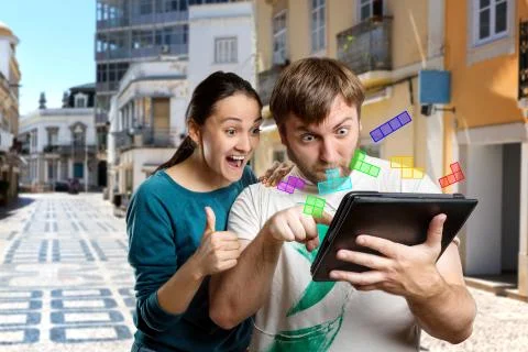 Couple playing with tablet Stock Photos
