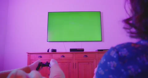Couple Playing Video Games Console Living Room Colorful Green Screen TV Stock-Footage 195288853