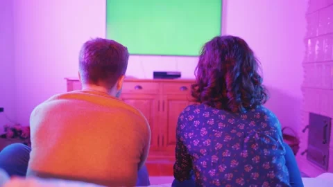 Couple Playing Video Games Console Living Room Colorful Green Screen TV Video stock 195289735