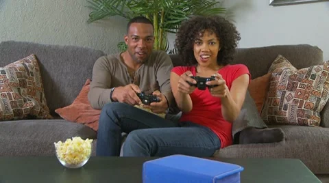 Couple playing video games on couch Stock-Footage 7730366