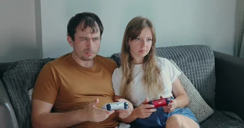 Couple playing video games couch home Stock Footage 305928913