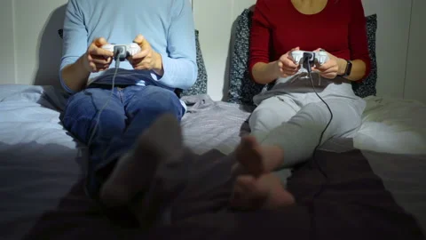 Couple playing video games in isolation. No faces. Stock Footage 169252394