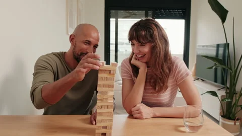 Couple Plays Jenga and Laughs at Home Stock Footage 313551623