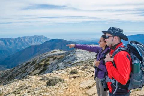 Couple pointing at the mountain Stock Photos