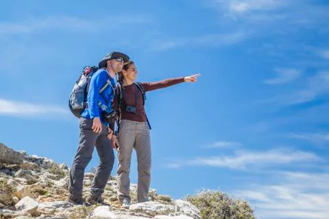 Couple pointing at the mountain Stock Photos