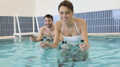 Couple in pool doing aquabike training Stock Footage 46758731