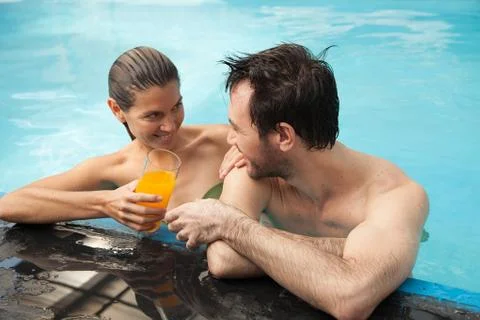 Couple in the pool having fun Fotos Stock