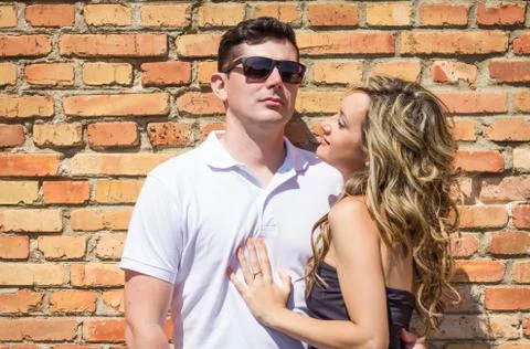 Couple portrait in front of brick wall Stock Photos