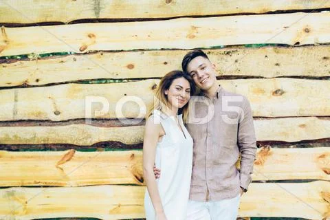 Couple posing on a background of the wooden wall Stock Photos