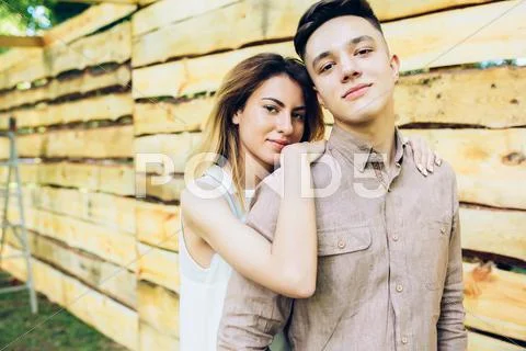 Couple posing on a background of the wooden wall Stock Photos