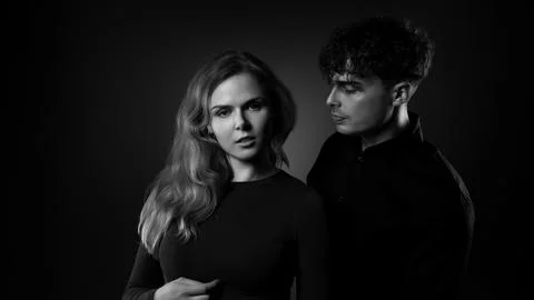 Couple posing with dramatic black and white studio lighting Stock Photos
