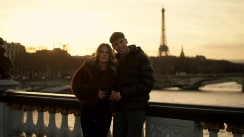 Couple posing in front of Eiffel Tower Paris France at sunset Romantic vacation Stock Footage 325262639