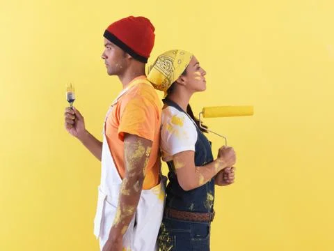 Couple posing in front of wall. Stock Photos