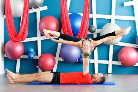 Couple practicing acro yoga in a studio. Acro yoga concept. Couple yoga class Stock Photos